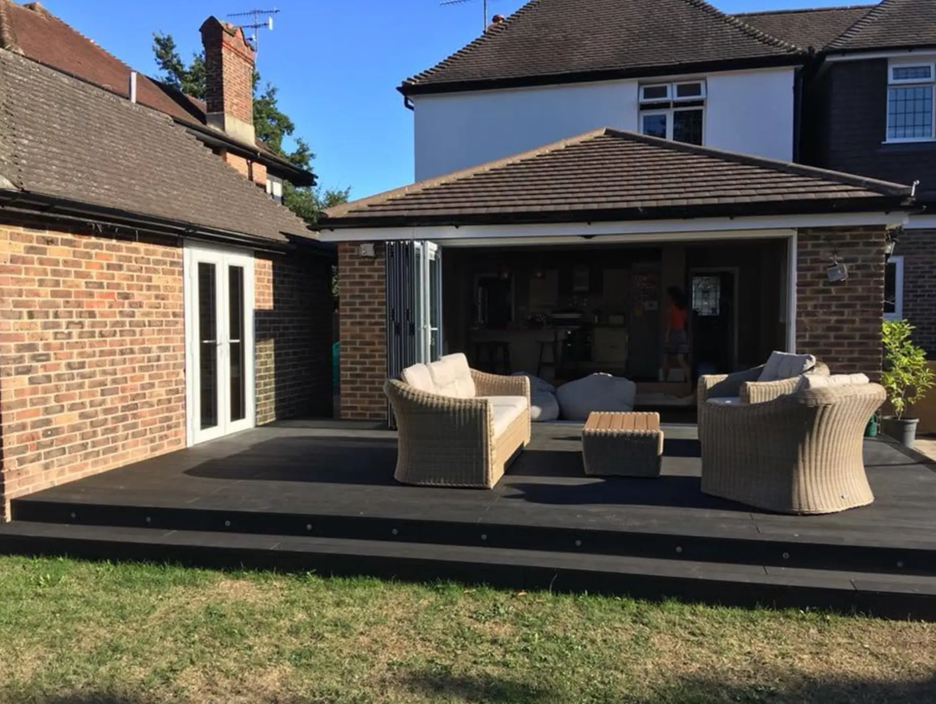 Bifold doors opened right back across a rear extension onto decking