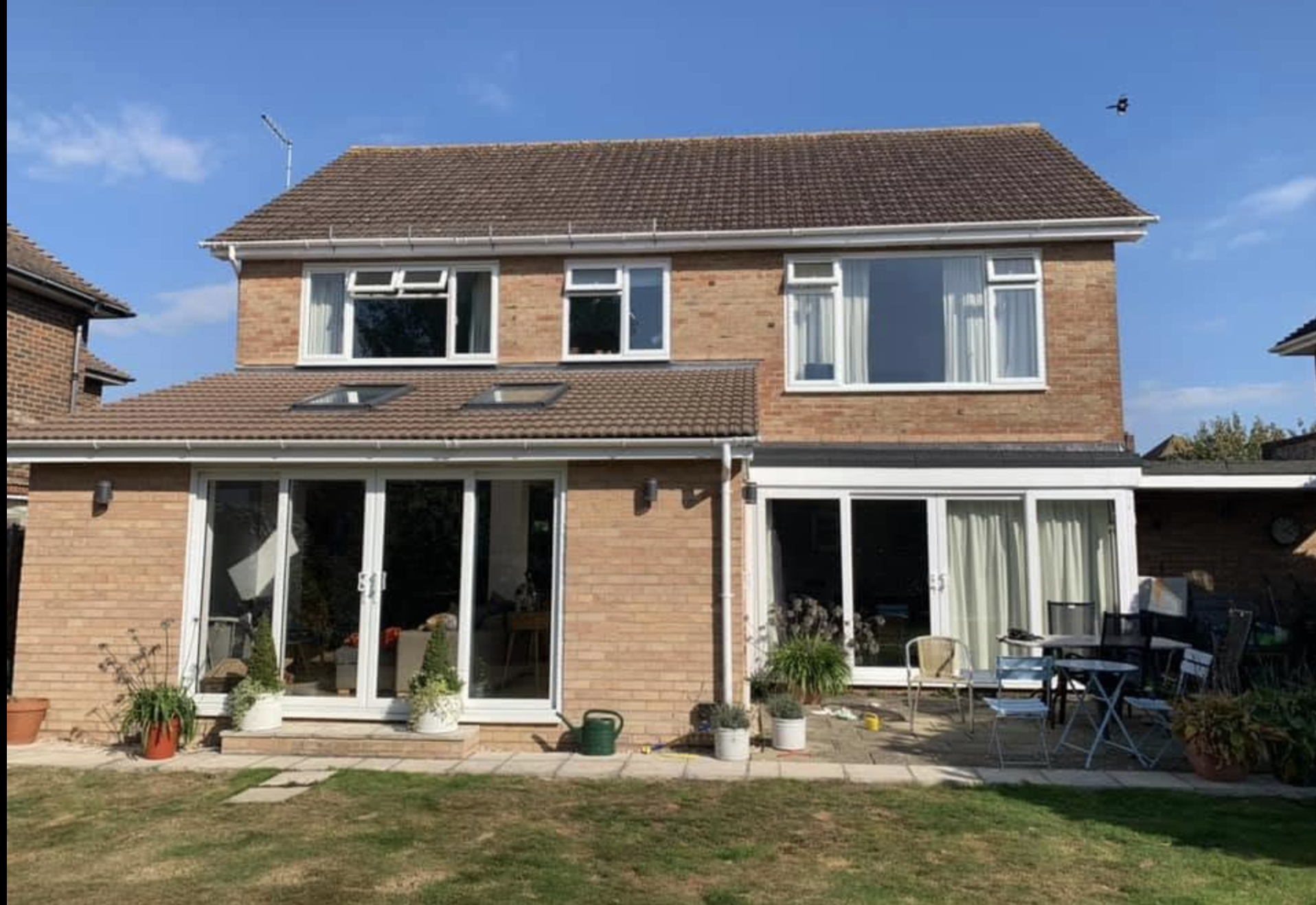 Rear of a detached house with new white fascias, soffits and guttering