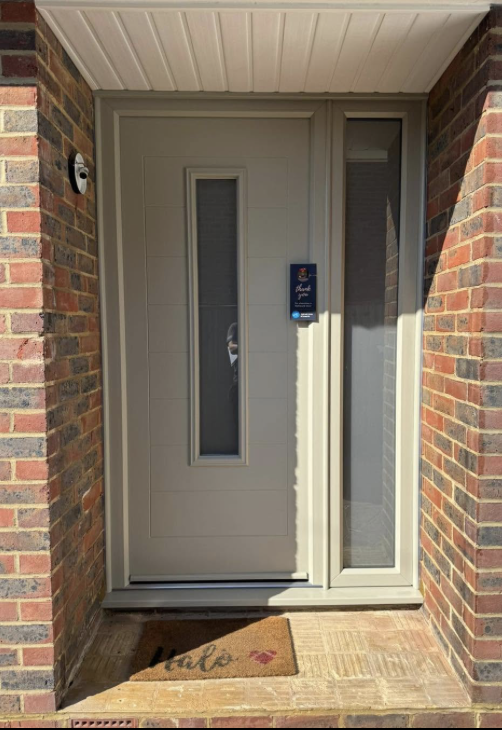 Cream composite front door with a glazed side panel