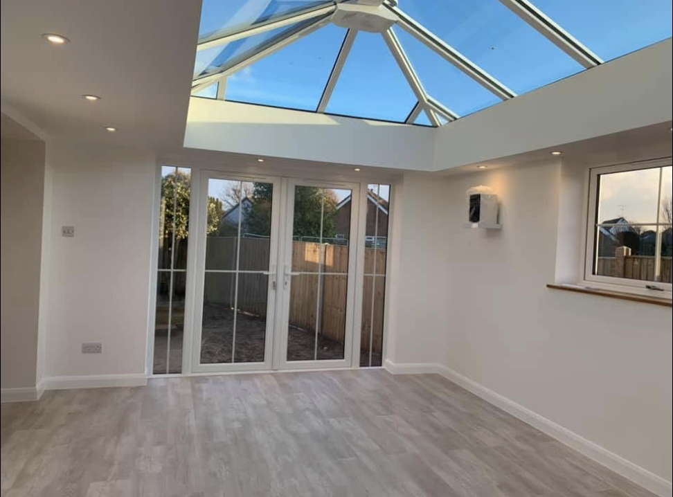 Inside a new orangery with a glazed lantern roof and French doors