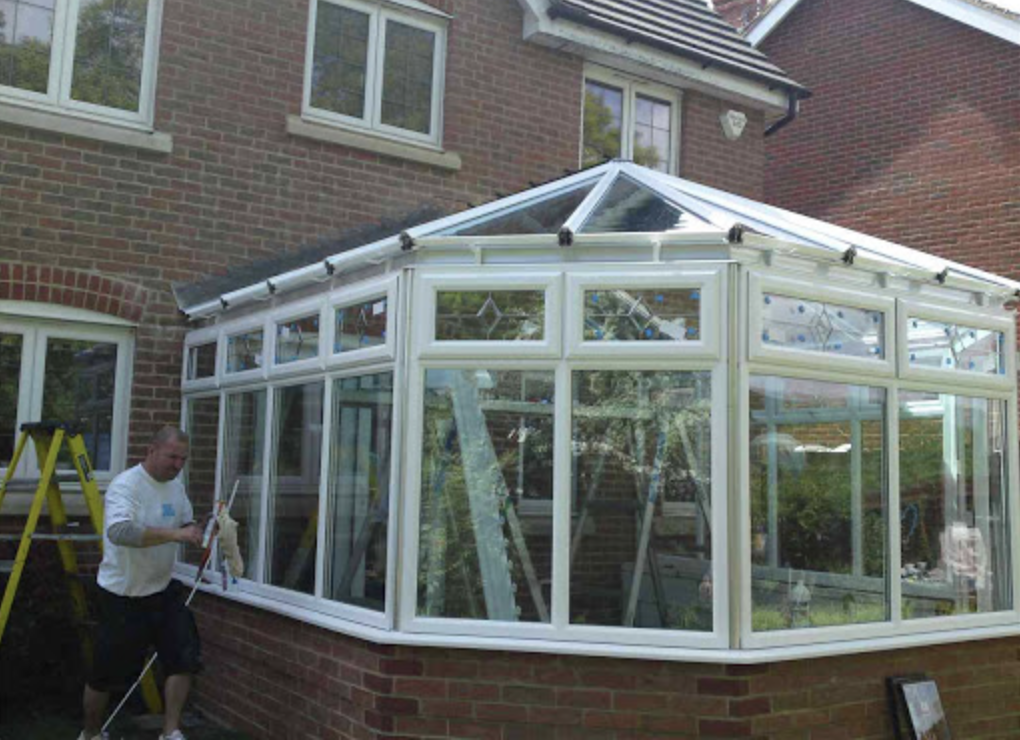 David fitting the glazing to a new white uPVC conservatory
